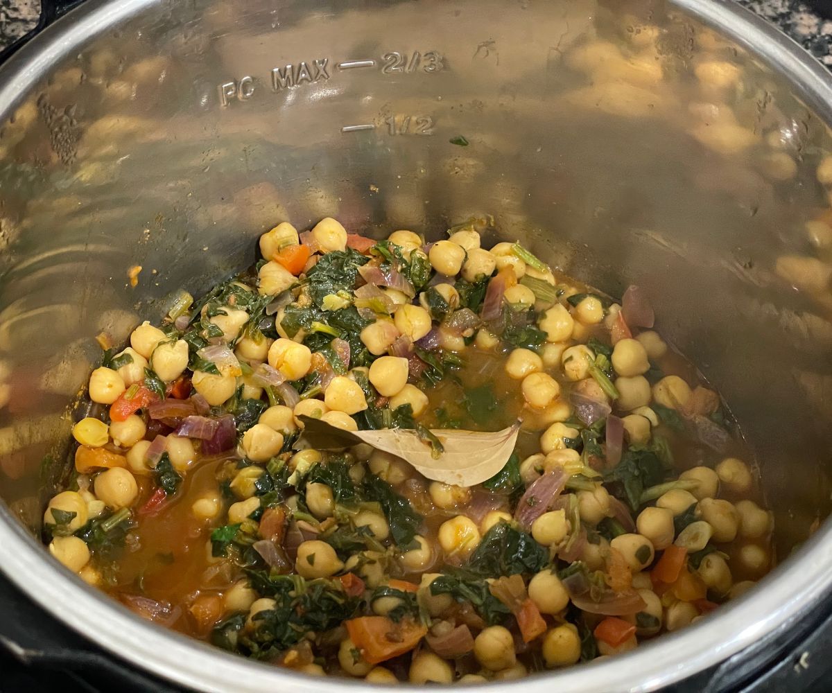 An instant pot is with chana saag curry.