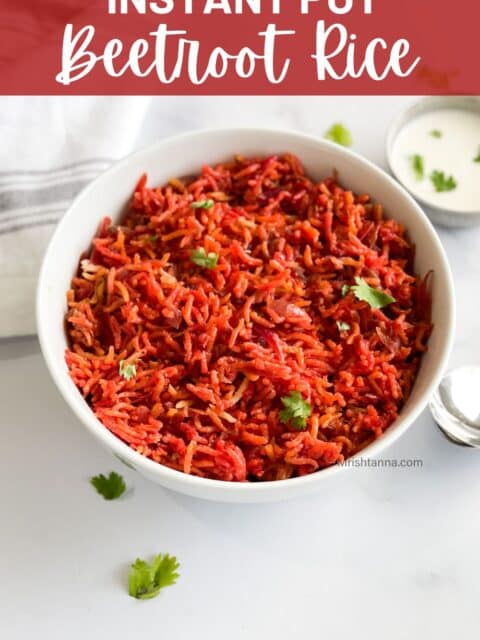 A bowl is filled with beetroot rice and topped with cilantro.