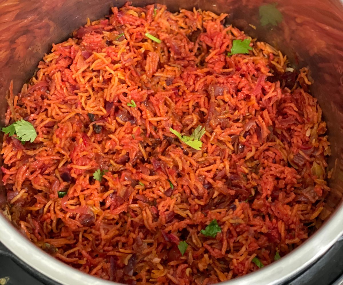 An instant pot is filled with beetroot rice.