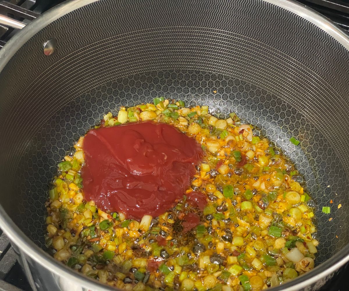 A pan is with lasun gobi sauce over the heat.