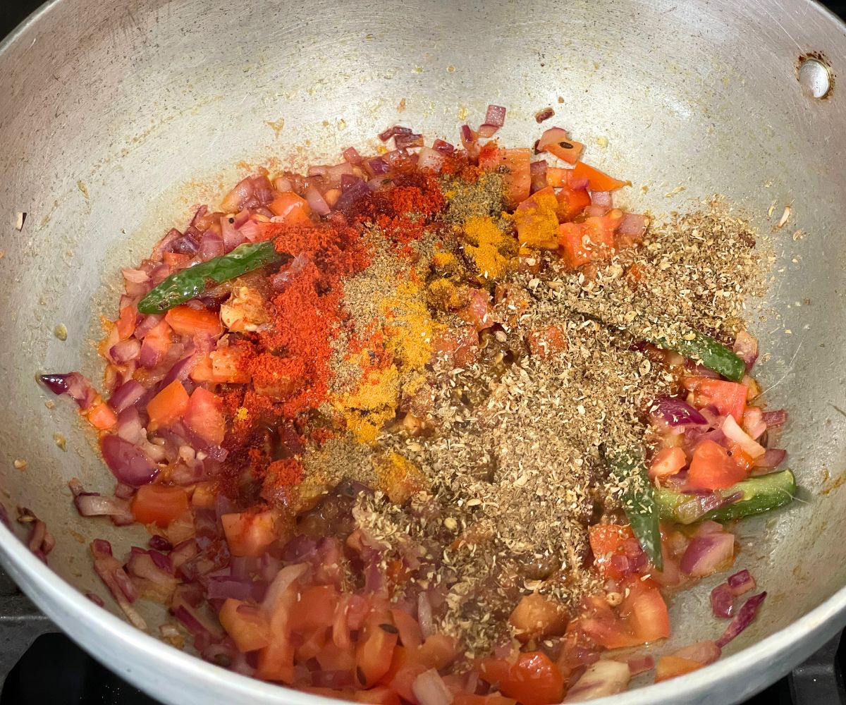 A pot of masala is on the stovetop.