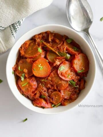 Indian radish curry is on the serving bowl.