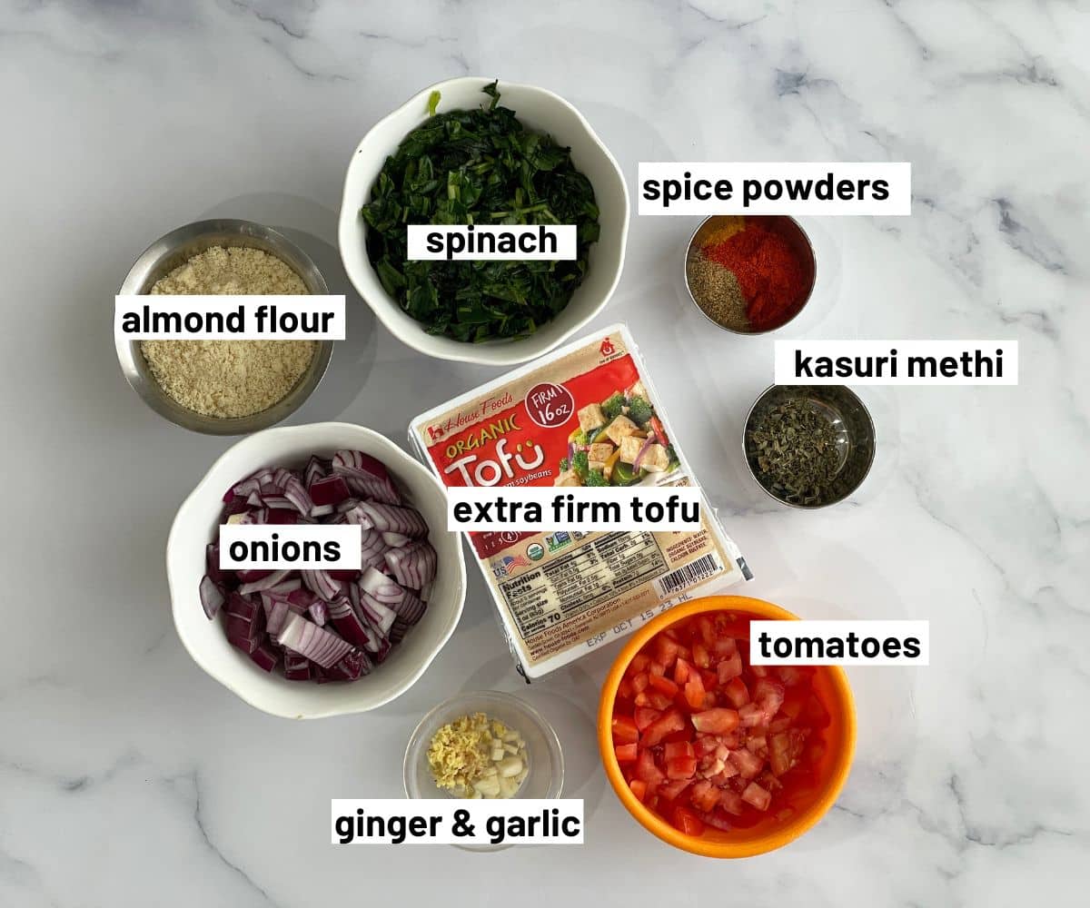 A table is covered with tofu curry ingredients.