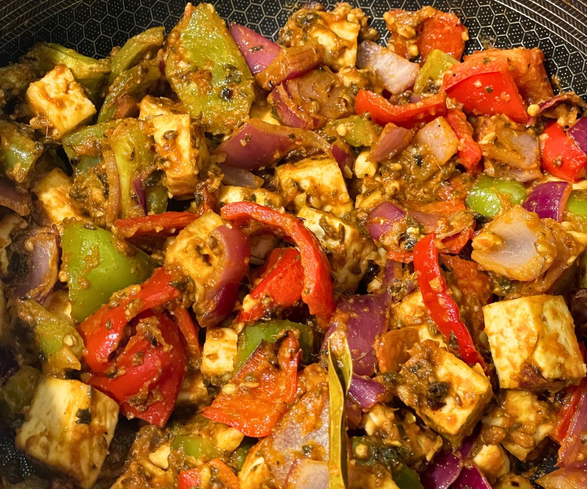 A pan is filled with tofu kadai Indian stir fry.