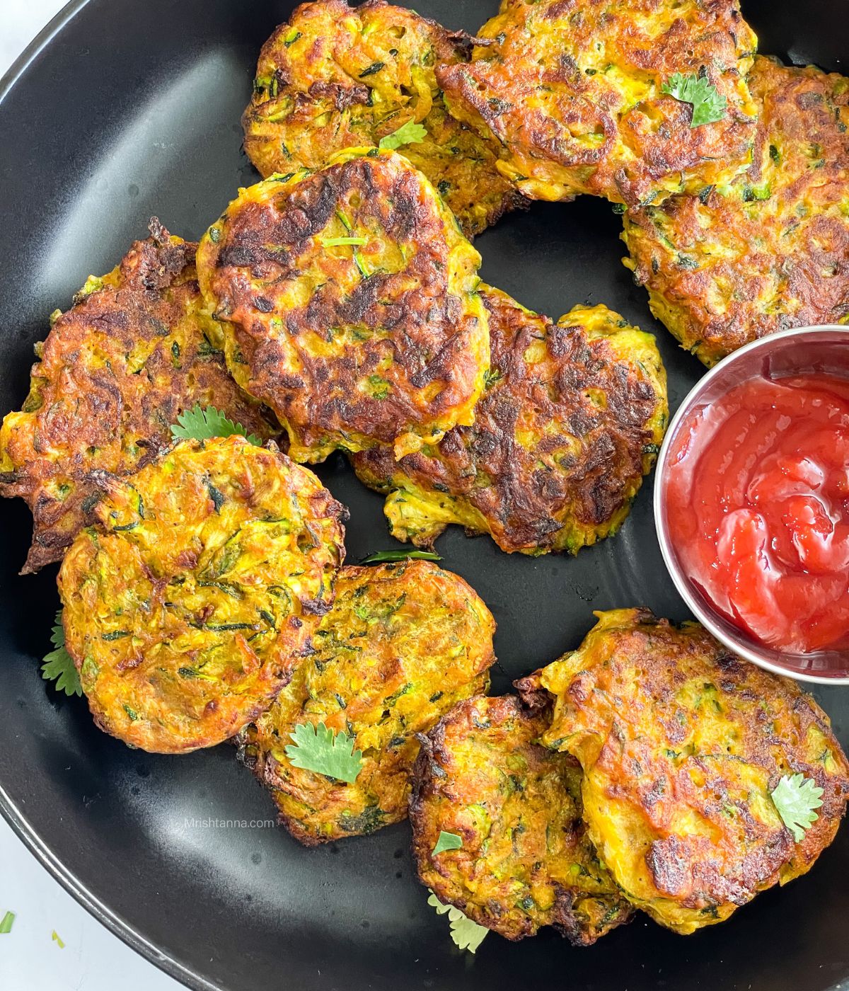 A plate is with air fryer zucchini fritters.