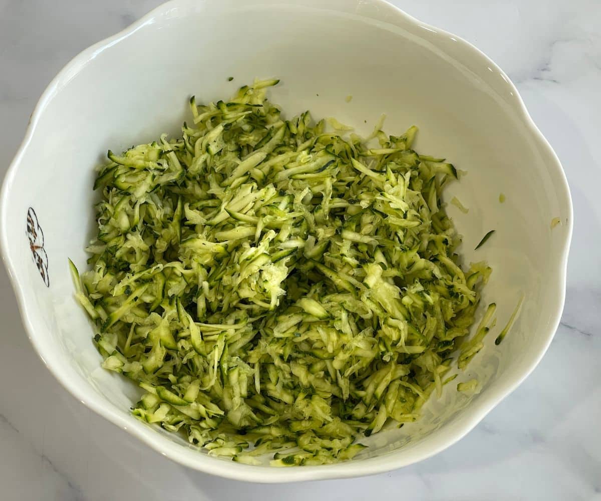 A bowl is filled with grated zucchini.