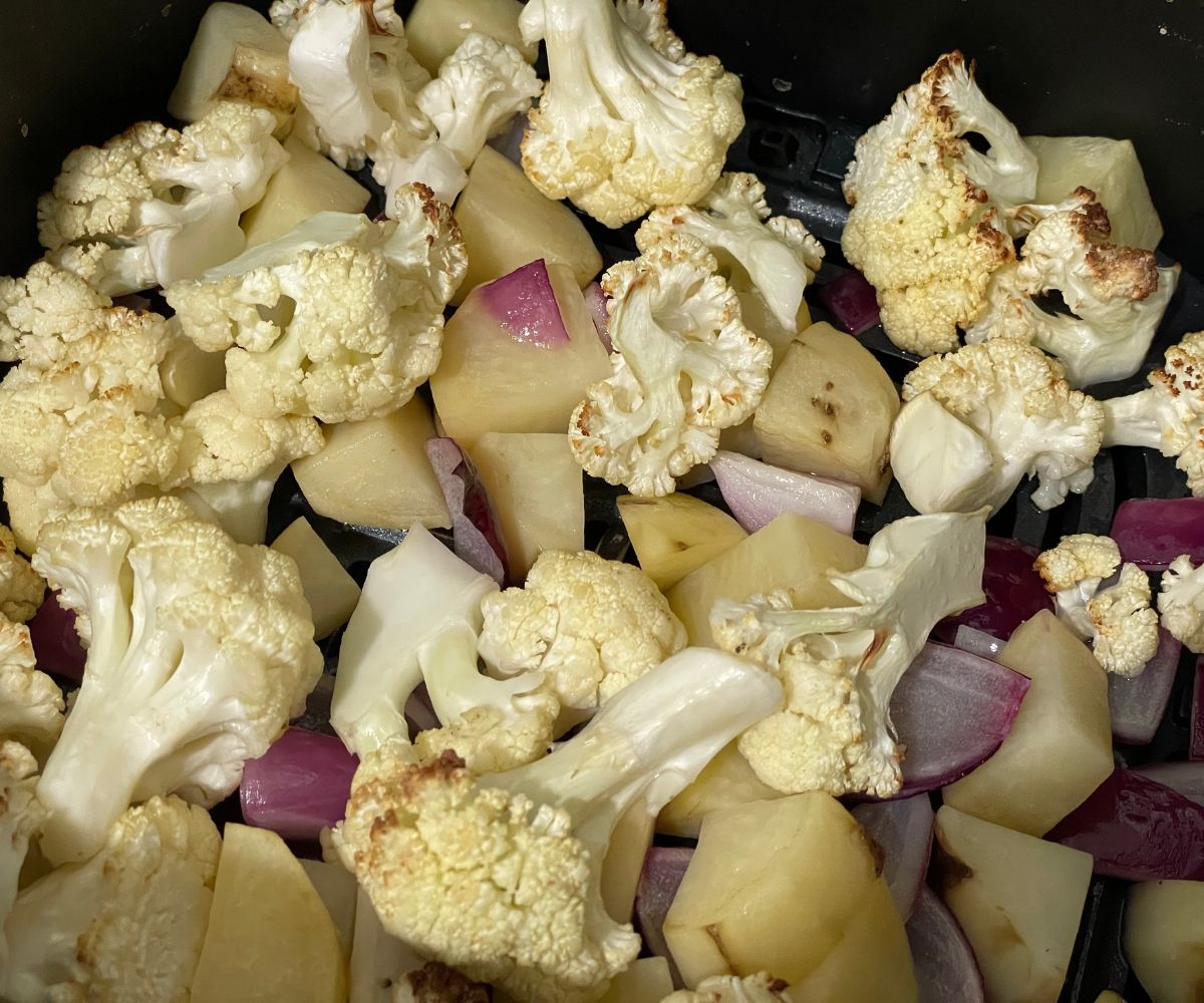 Air fryer basket is with roasted aloo gobi.