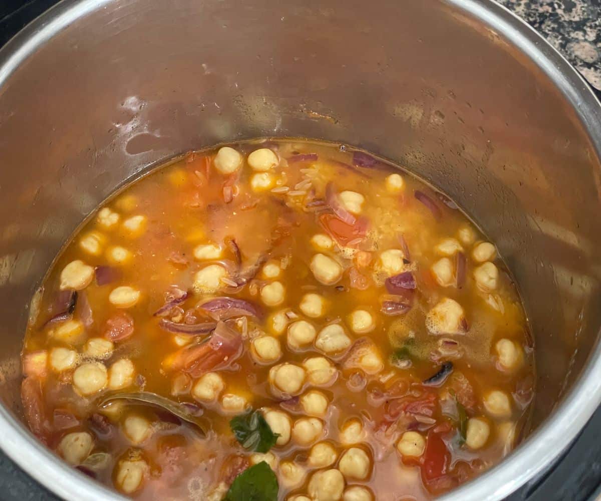 A pot is with chana pulao raw mixture.
