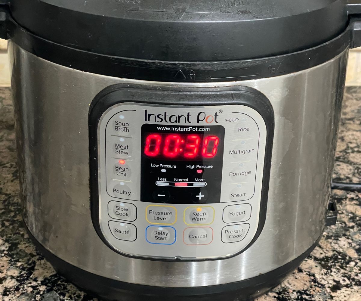 An instant pot is with Kidney beans cooking on chili mode.