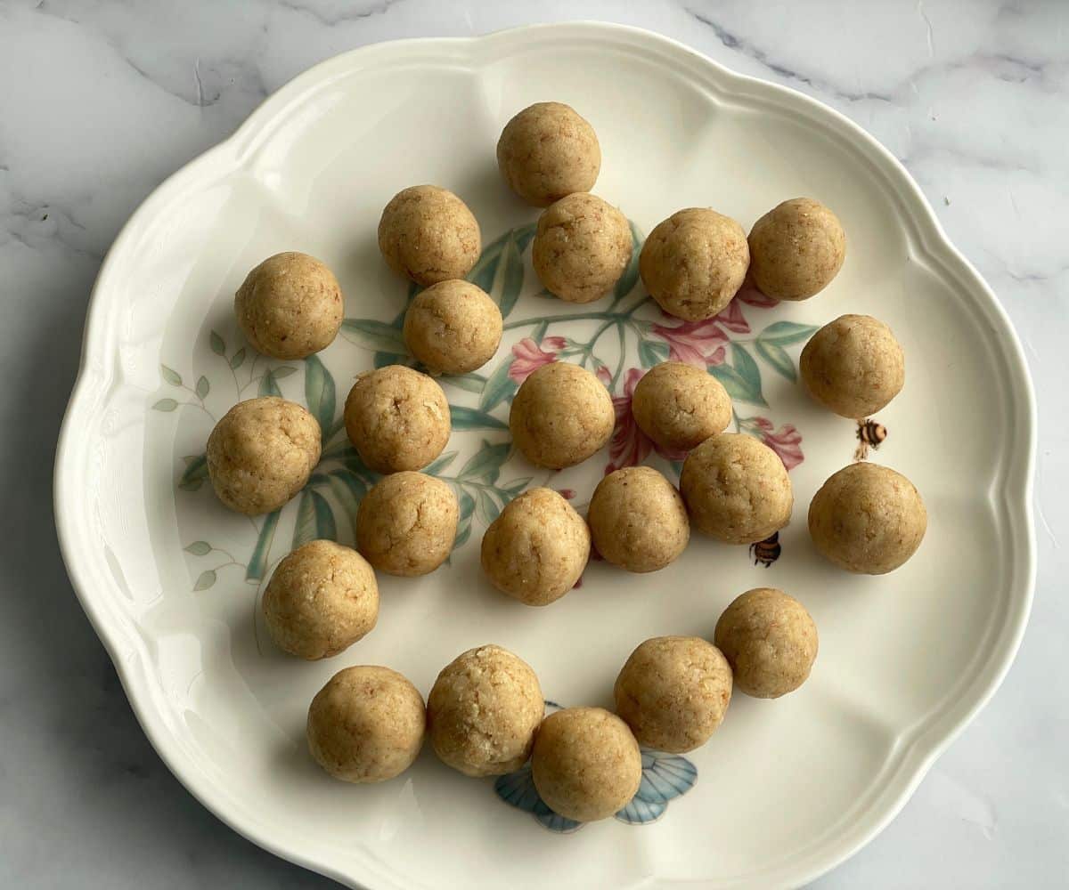 A plate is with vegan gulab jamun balls.