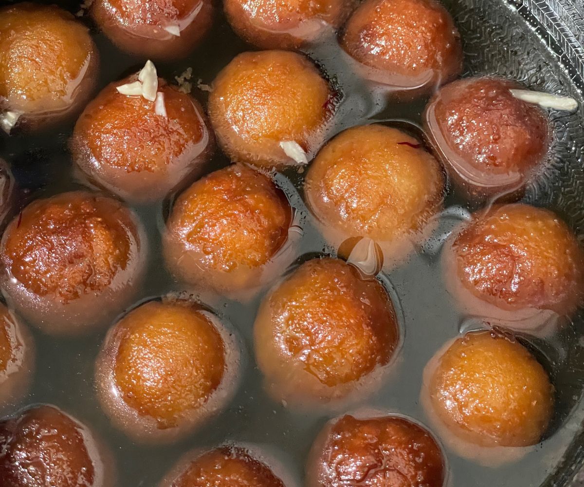 A pot is with vegan gulab jamuns.