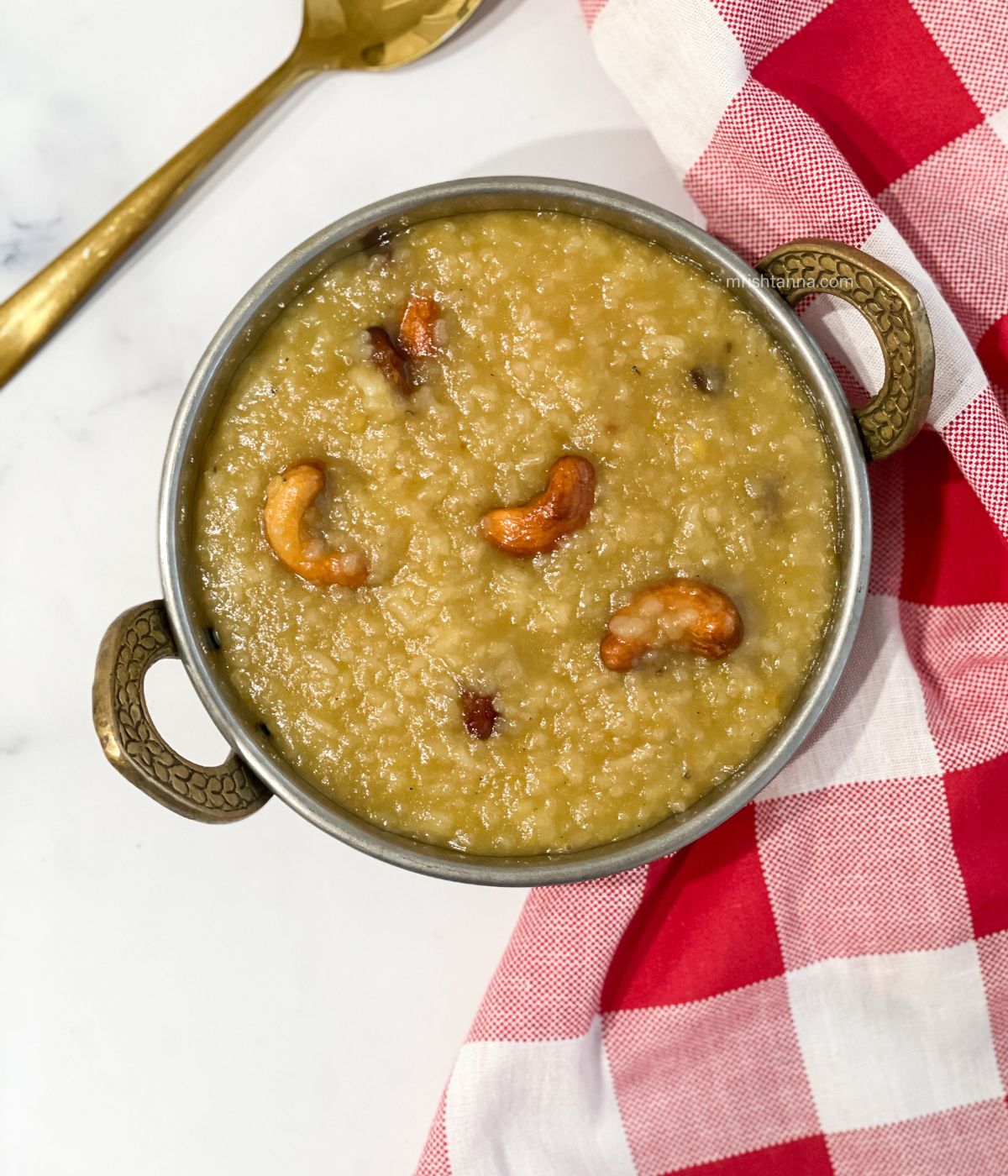 A bowl is filled with vegan sweet pongal.