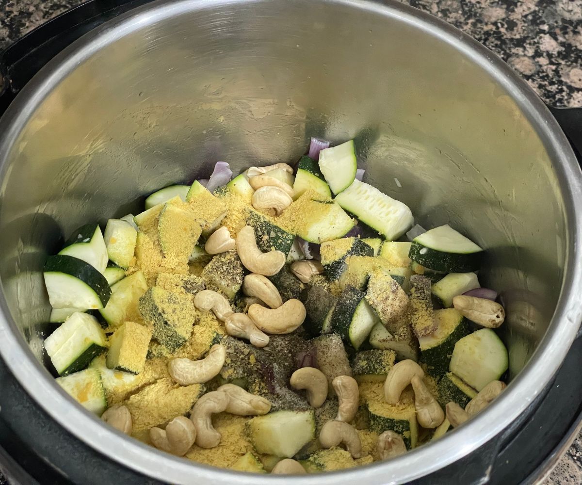 A pot is with vegan zucchini soup ingredients.
