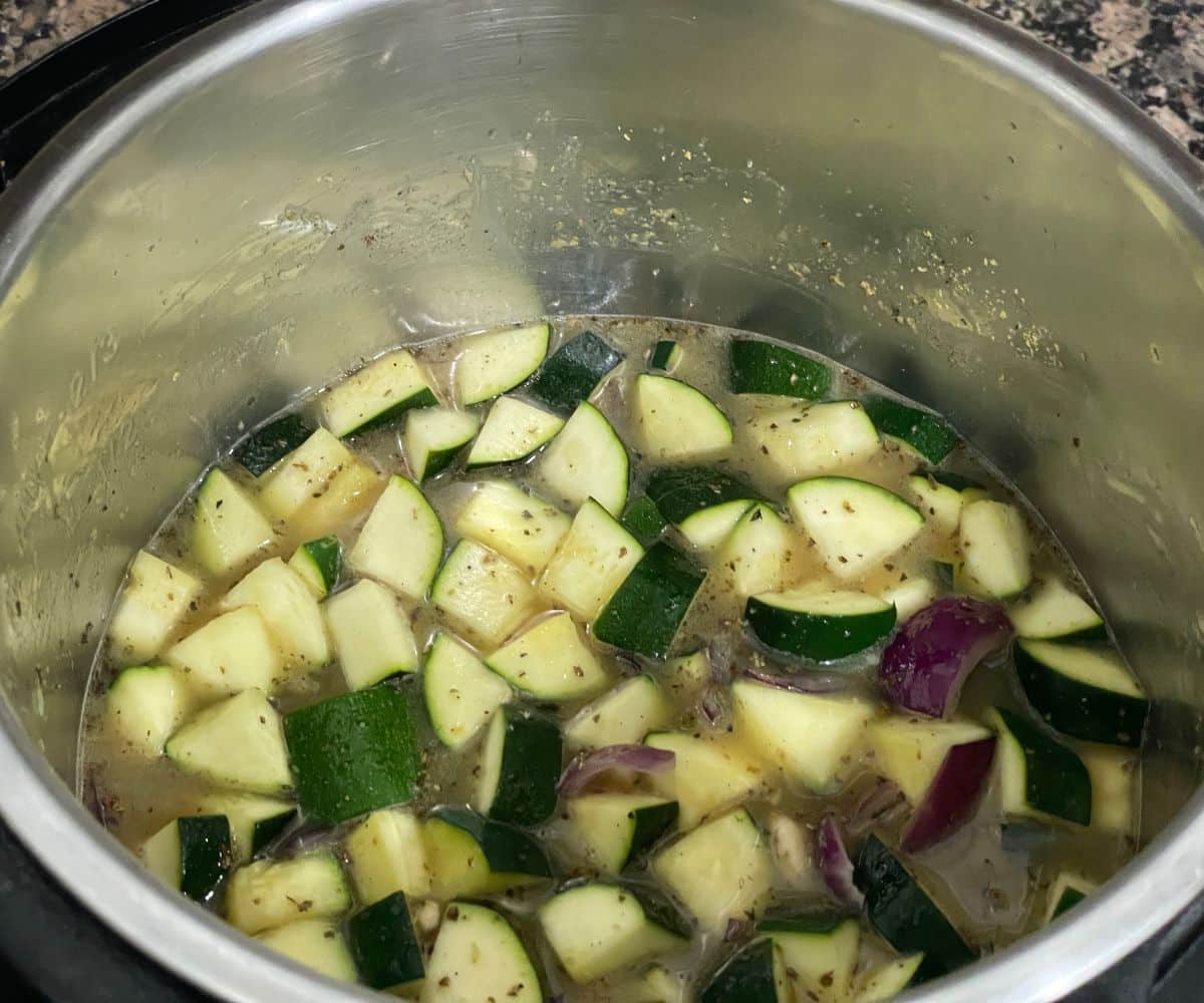 A pot is filled with zucchini soup mixture.