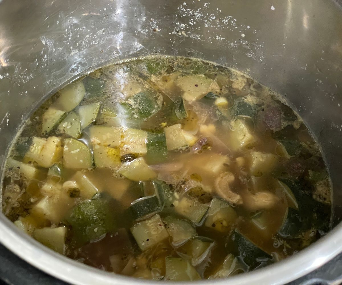 An instant pot is with zucchini soup mixture.