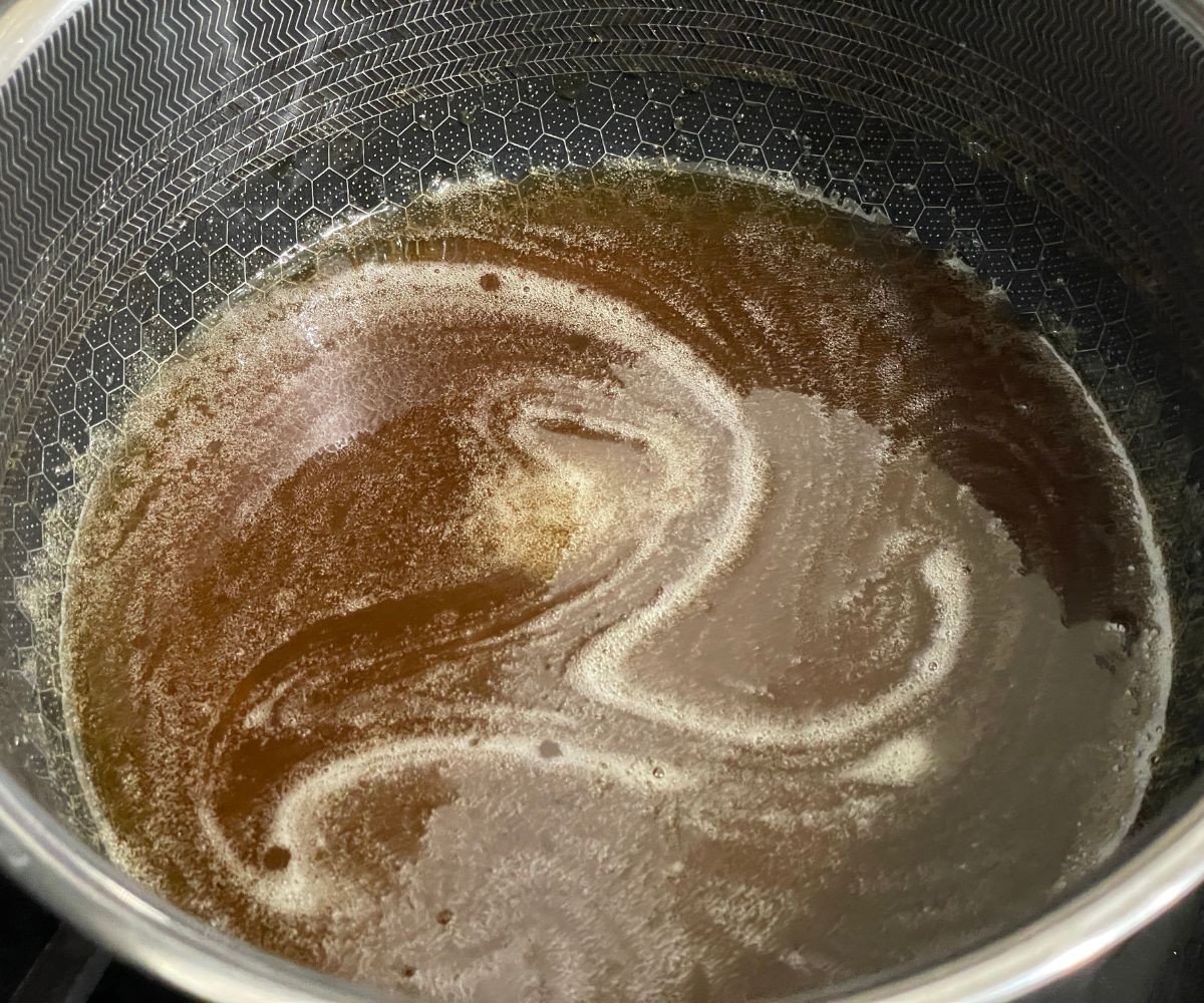 A pot is with jaggery syrup.