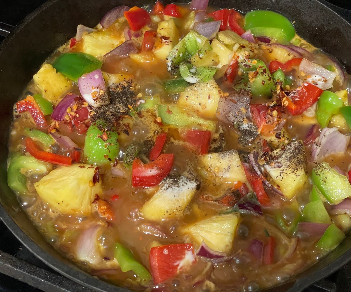 Pineapple tofu stir fry is cooking in the pan.