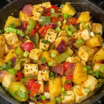 A skillet is filled with pineapple tofu stir fry.