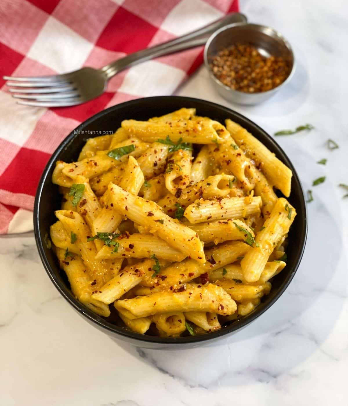 A bowl of Pumpkin pasta is on the surface.