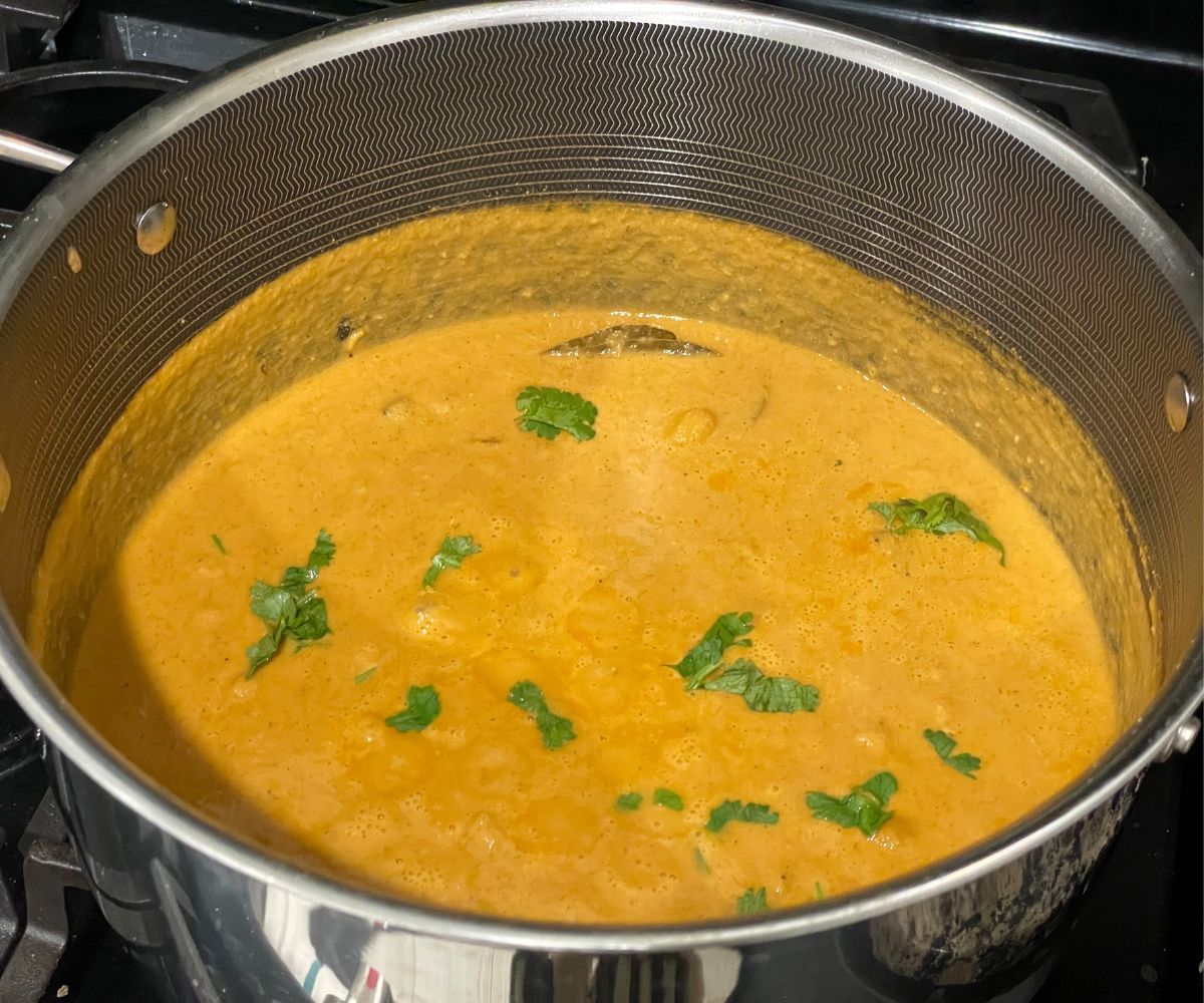A pot of South Indian chana masala curry is on the stove top.