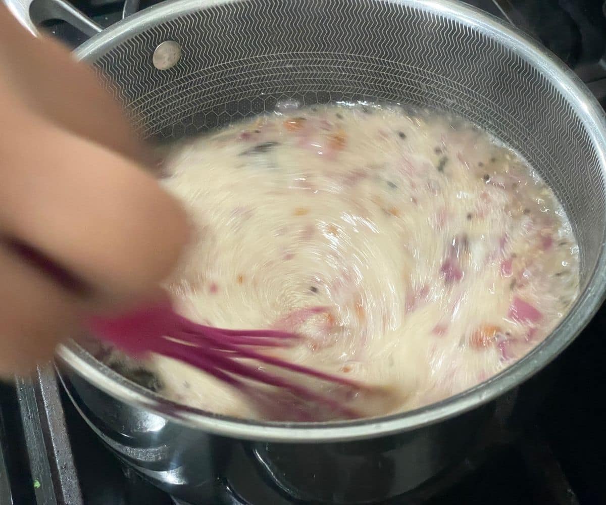 Stirring continuously rava upam to avoid lumps.