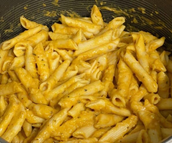 A pot of Vegan Pumpkin pasta is on the stove top.