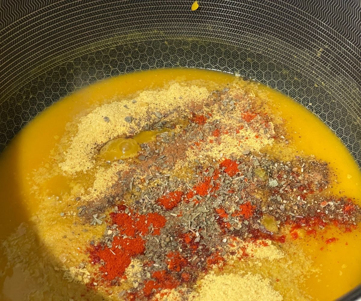 A sauce pan is with all the ingredients for pumpkin pasta sauce.