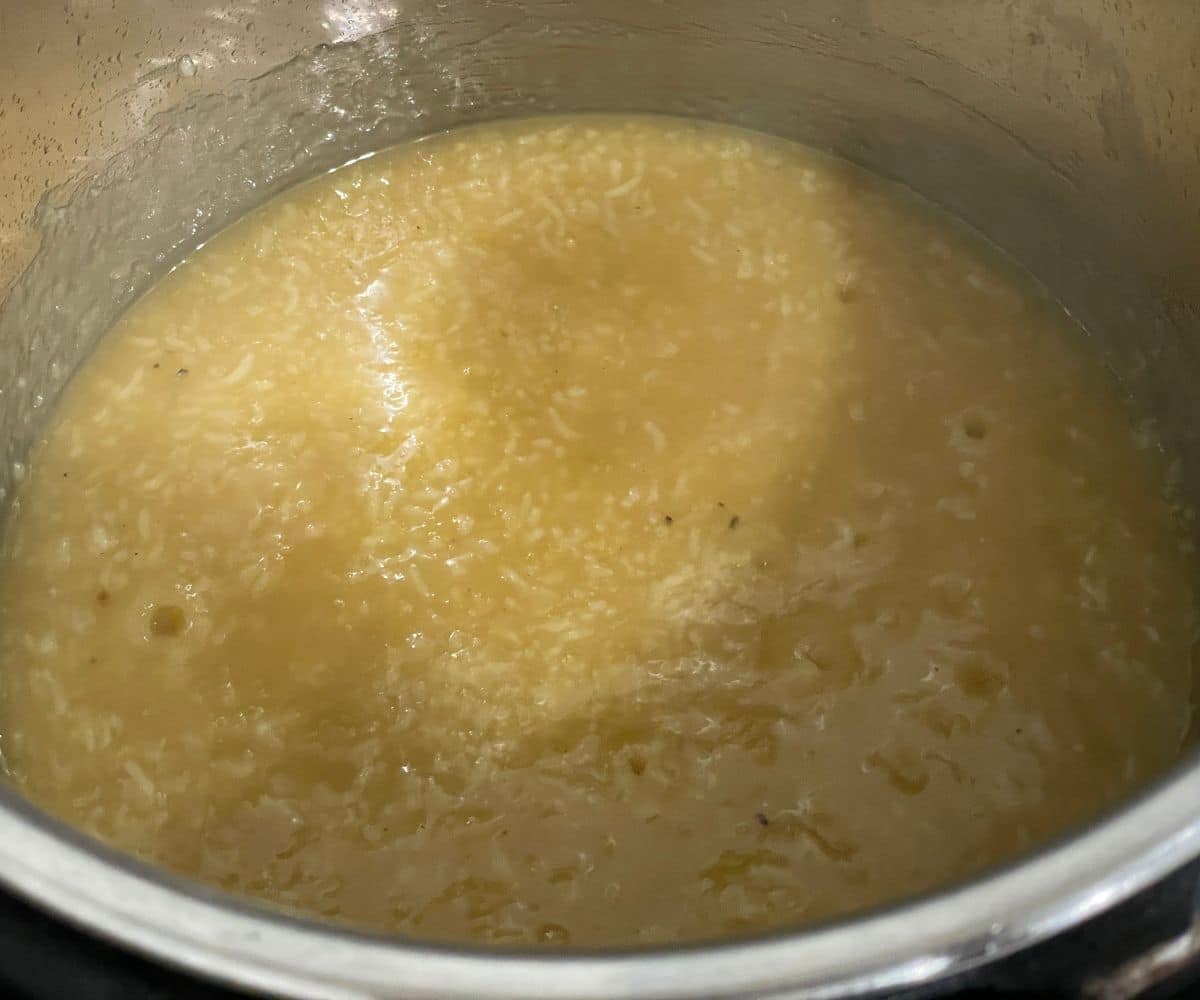 A pot is with  sweet pongal.