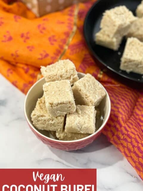 A bowl is with a stack of coconut burfi's.