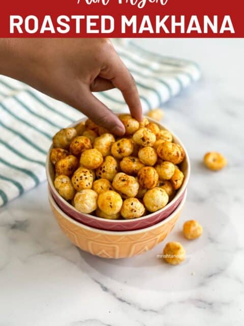 A bowl of roasted makhana is on the table and a kid's hand is picking up one from it.