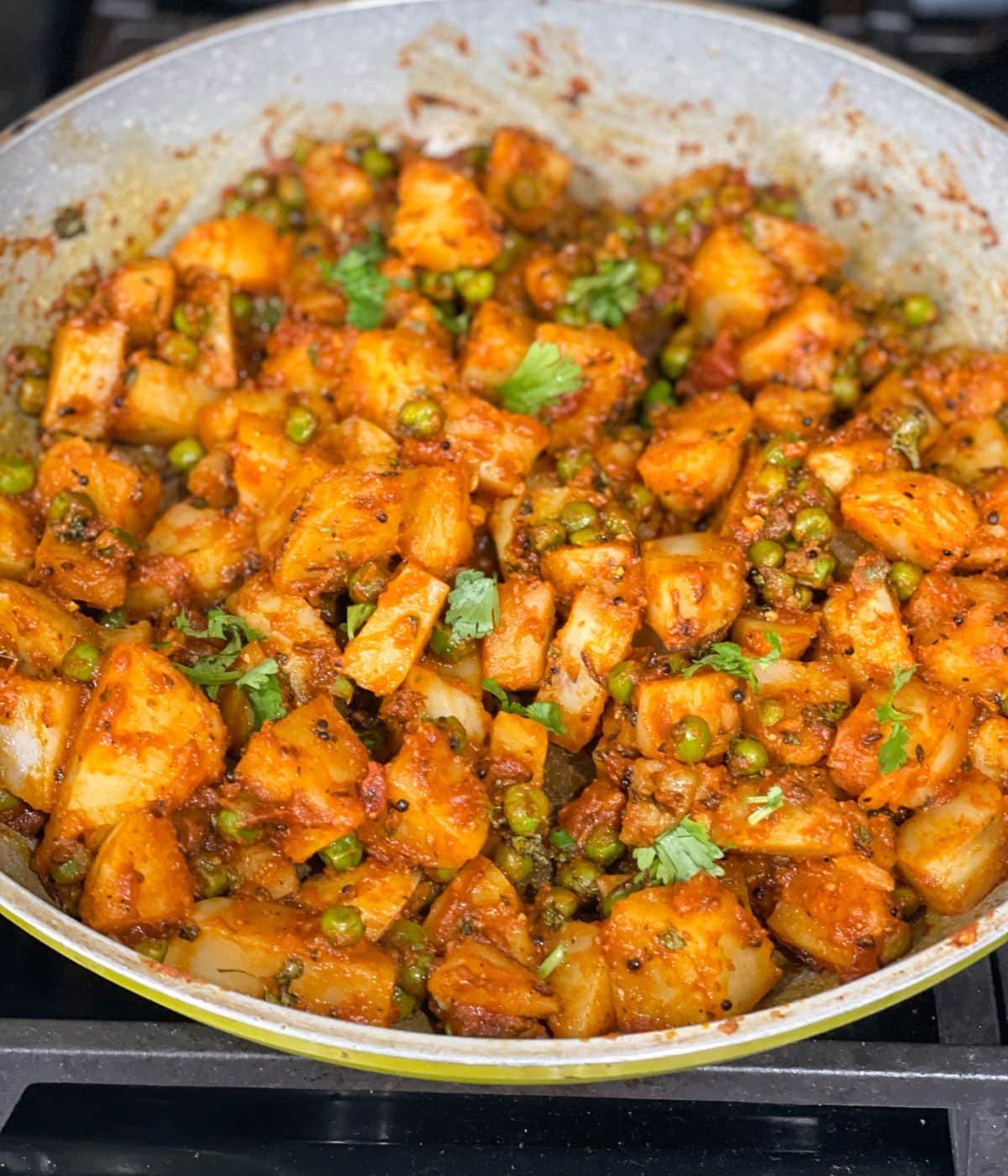 A pan has aloo matar dry sabzi.