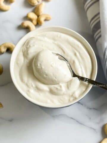 A spoonful of cashew yogurt is in the bowl.