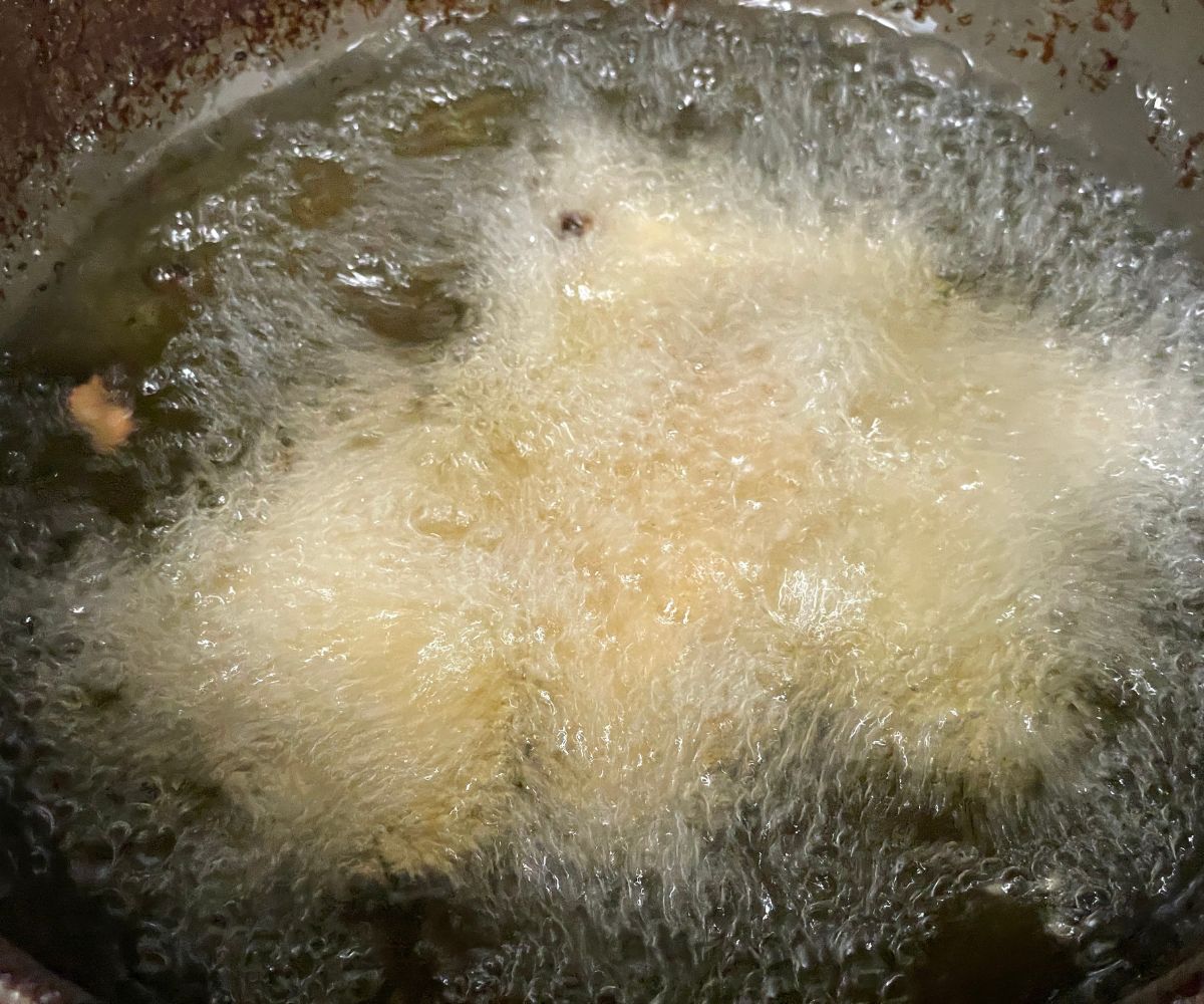 Frying gluten free samosas.