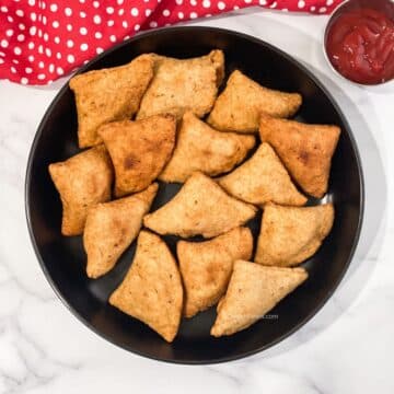 A plate has vegan gluten free samosas.