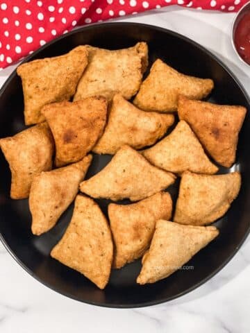 A plate has vegan gluten free samosas.