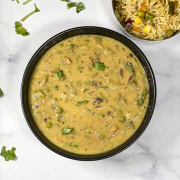 A bowl is full of avarekalu curry.