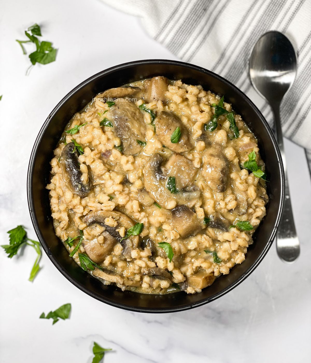 A bowl is full of barley risotto.