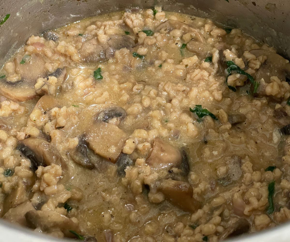 A pot has barley mushroom risotto.