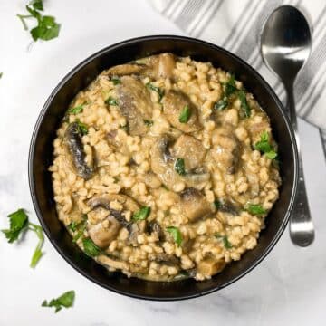 A bowl of barley mushroom risotto is on the table.