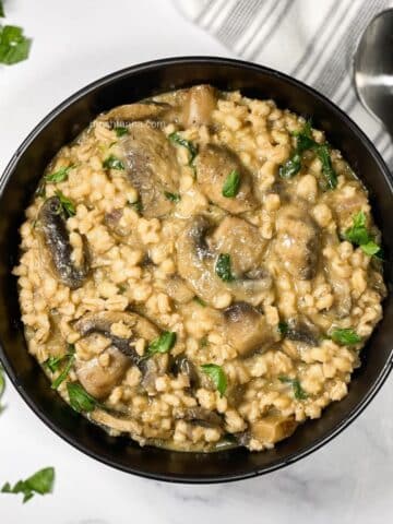 A bowl of barley mushroom risotto is on the table.