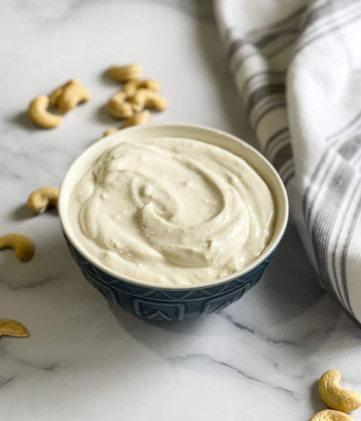 A bowl of cashew yogurt is on the table.