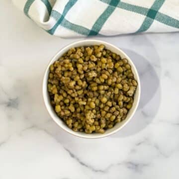 A bowl of mung beans are on the table.