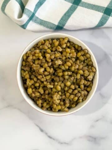 A bowl of mung beans are on the table.