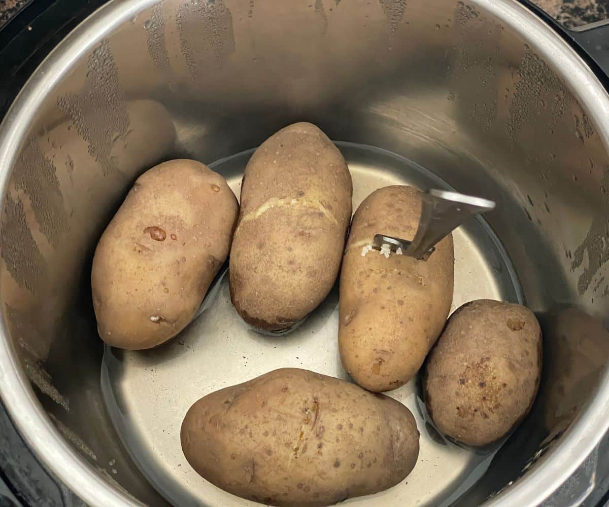 An Instant pot is with boiled potatoes.