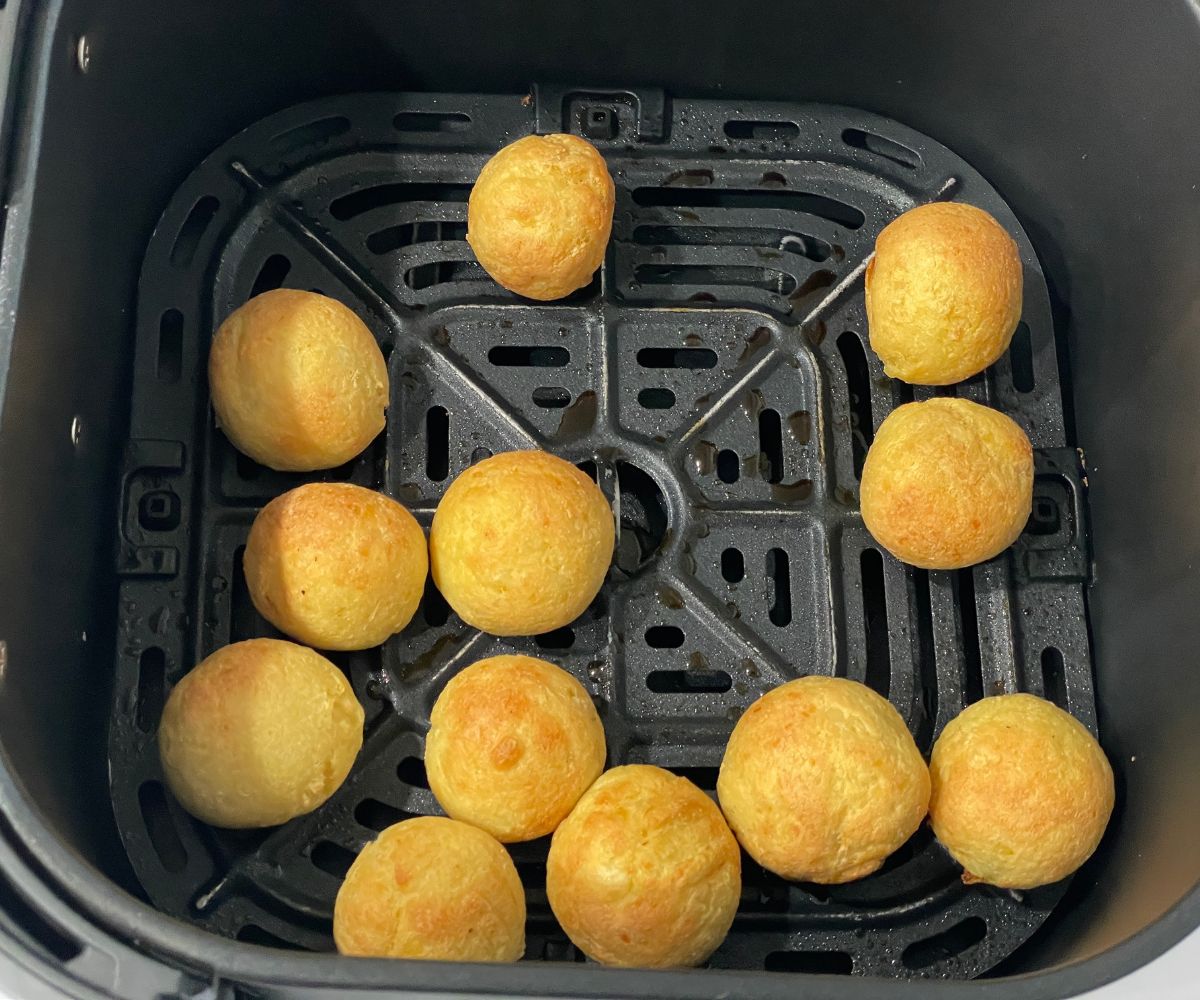 Air fryer basket has fried malai kofta balls.