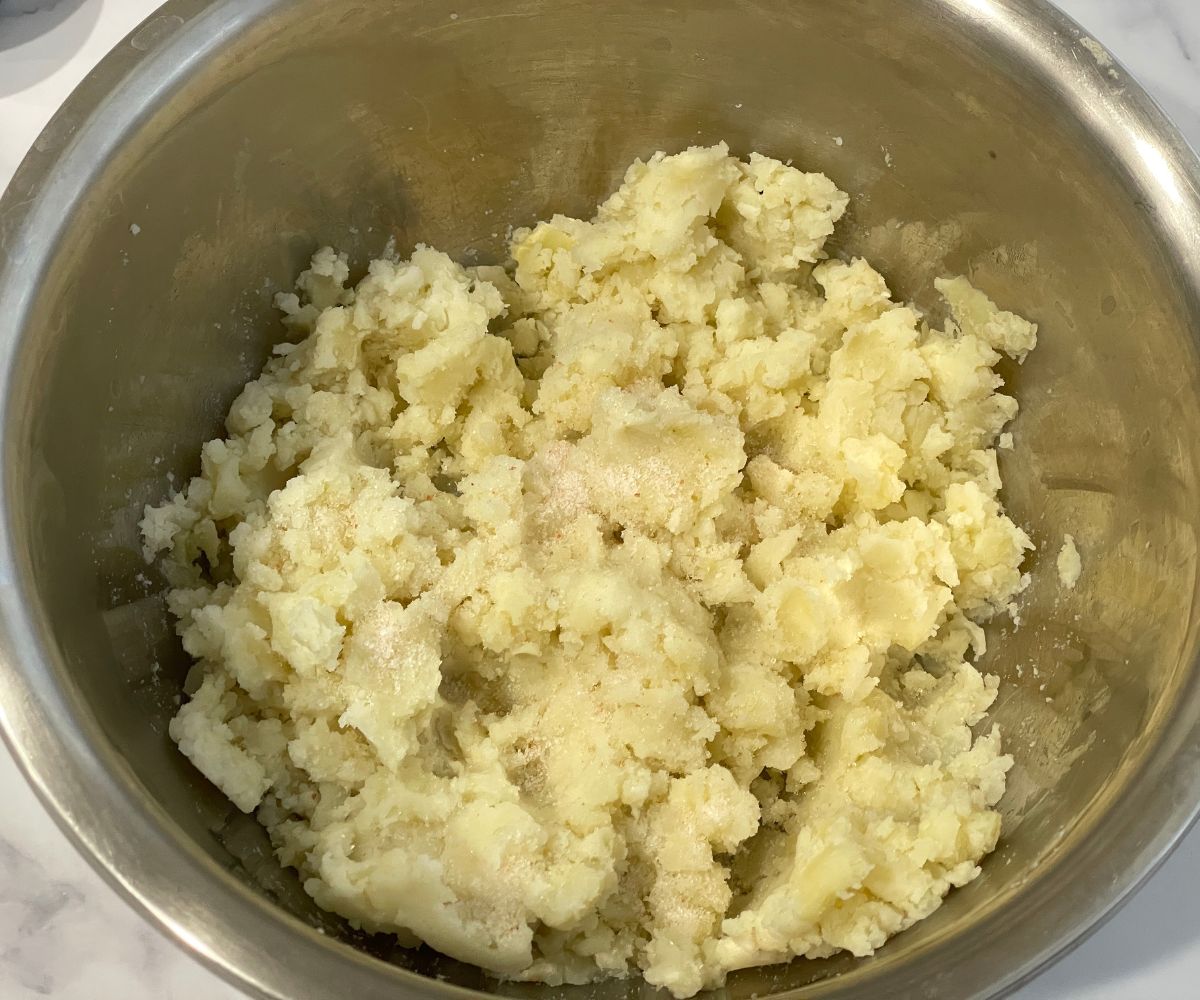 A bowl has mashed potatoes.