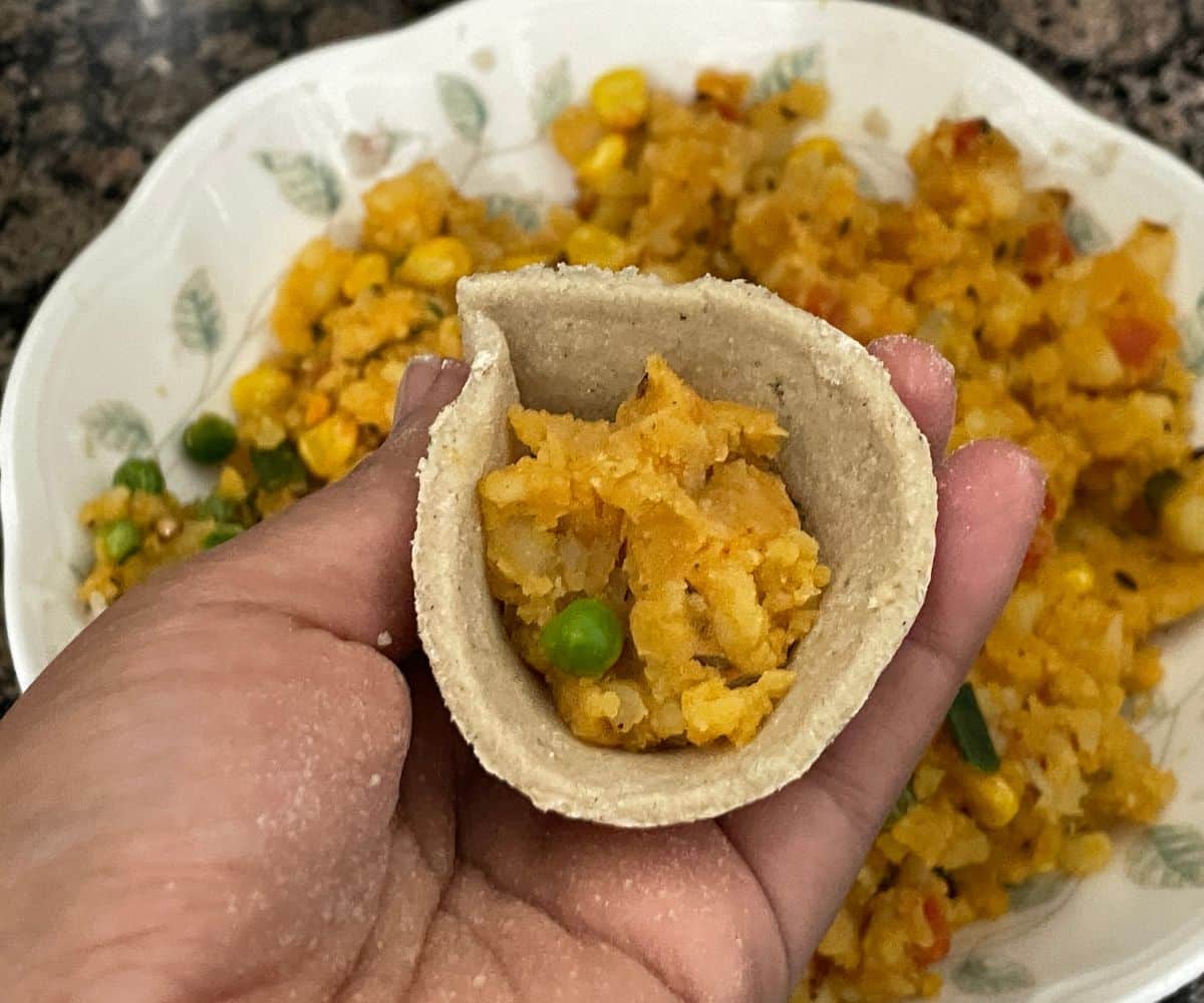 Samosa cone is filled with potato filling.