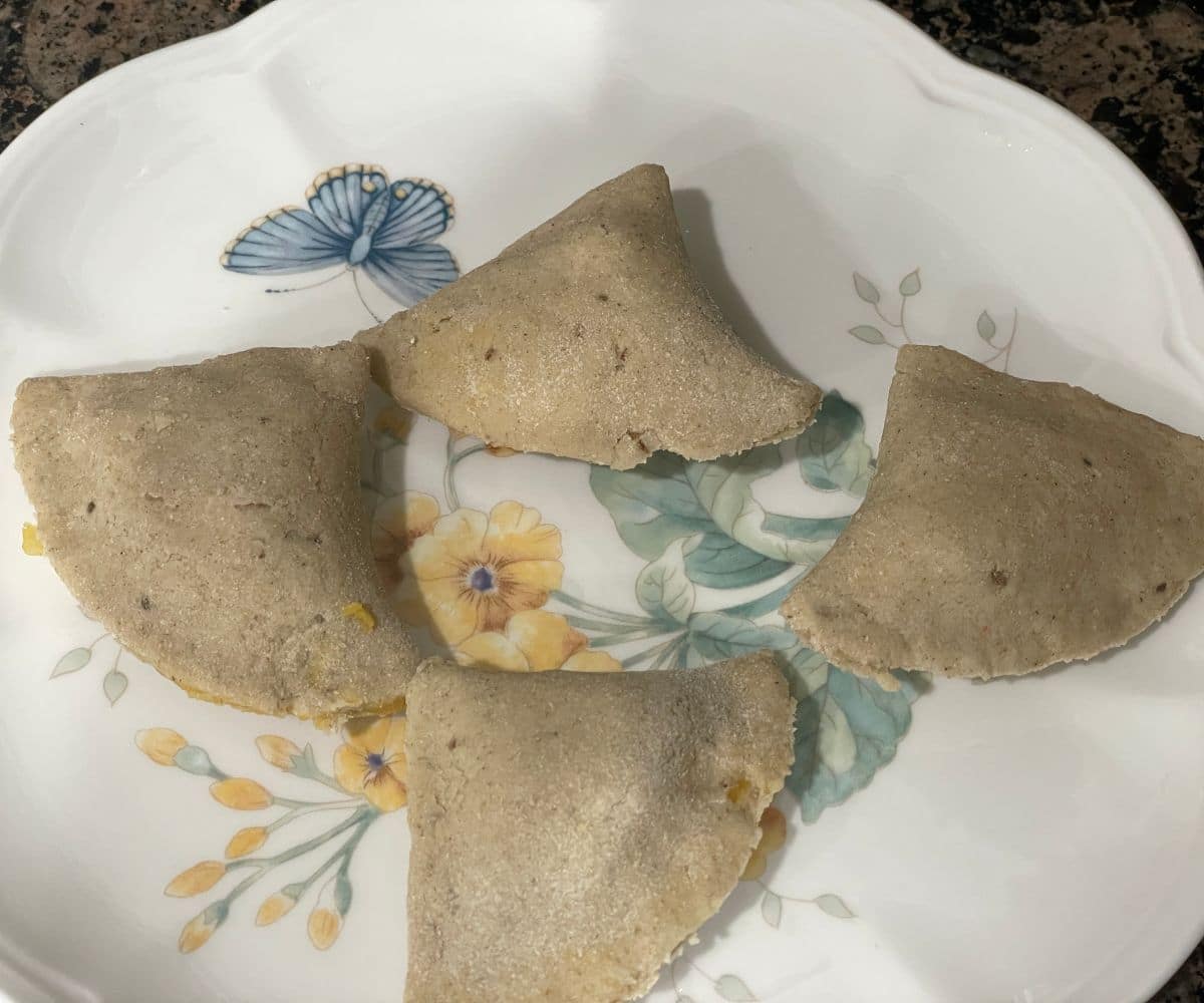 A plate full of stuffed gluten free samosas.