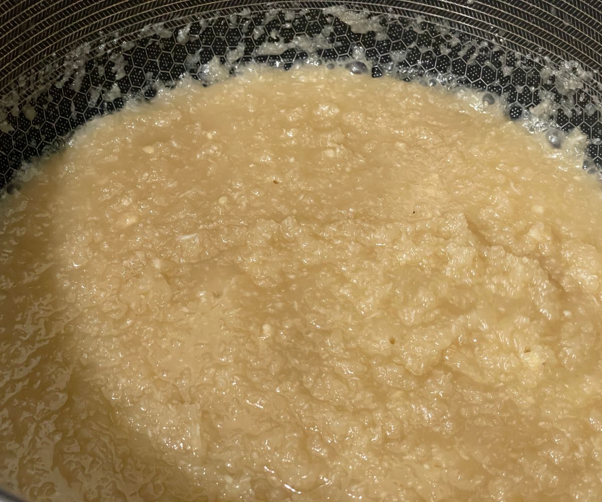 A pan is with coconut burfi mixture.