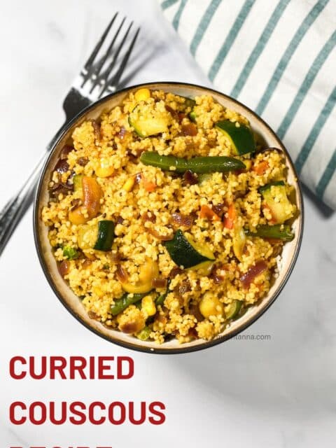 A bowl has curried couscous salad.